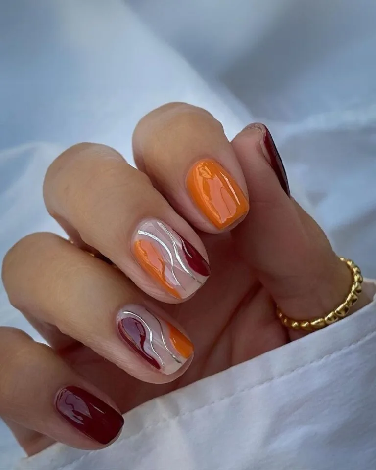 Burgundy-and-orange-nails-with-silver-accent-lines